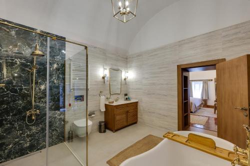 a bathroom with a shower and a tub and a sink at Silk Road Museum Hotel in Tokat