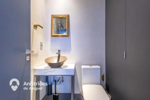 a bathroom with a sink and a toilet at Cobertura Duplex Vista Cidade Centro TV4061 in Blumenau
