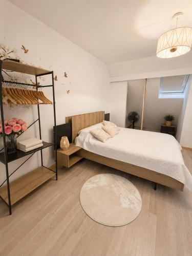 a bedroom with a bed and a shelf with roses at Maison de charme avec Jacuzzi privé in Sarcelles
