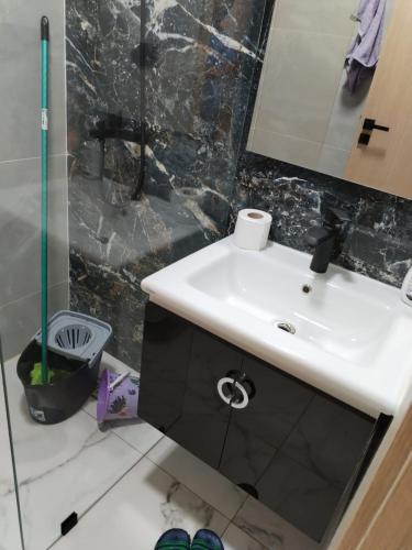 a bathroom with a sink and a mirror at Apprtmnt jury de luxe 6 in Nador