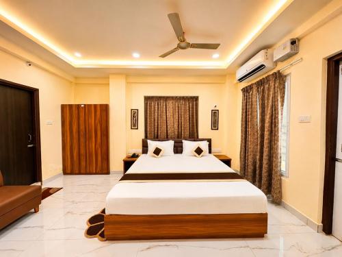 a bedroom with a bed and a ceiling fan at Hotel Pushparaj Puri - Beach front Hotel near Light House - Sea Facing AC Rooms - with Restaurant, Parking Facilities in Puri
