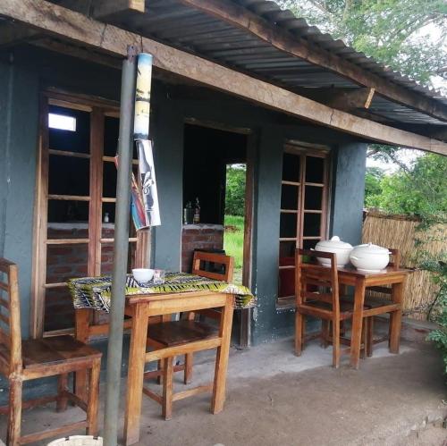 a wooden table and chairs on a patio at Mabuu Drive Inn in Waya