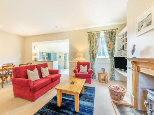 a living room with a red couch and a fireplace at Wellwood - Uk49290 in Preston