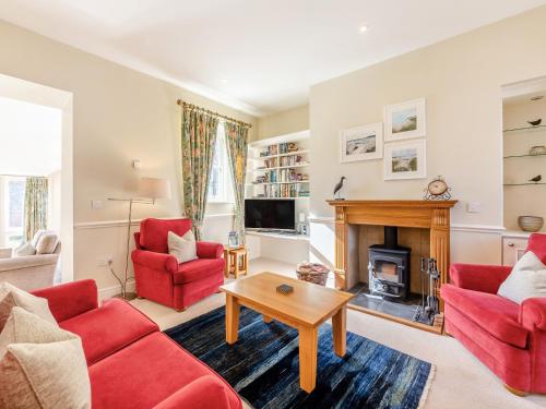 a living room with red furniture and a fireplace at Wellwood - Uk49290 in Preston