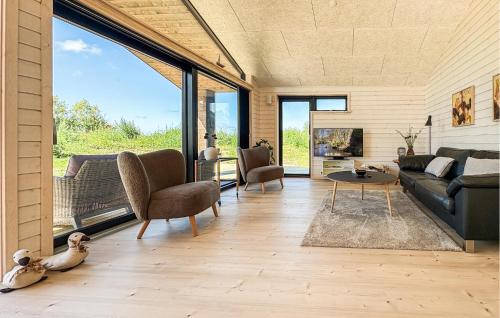a living room with a couch and a table at 3 Bedroom Beautiful Home In Fjerritslev in Fjerritslev