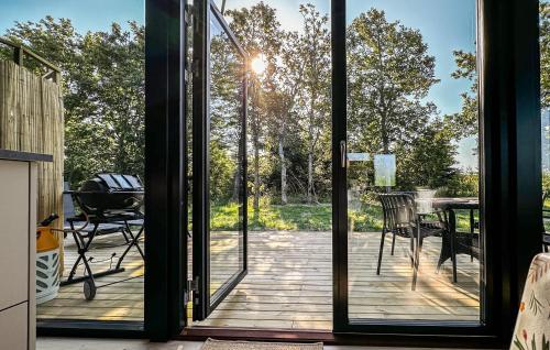 an open door to a deck with a grill at 3 Bedroom Beautiful Home In Fjerritslev in Fjerritslev