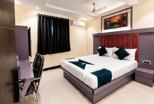 a hotel room with a bed and a television at Hotel Taj Palace - Near Mumbai Airport in Mumbai