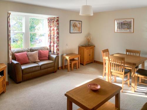 a living room with a couch and a table at 1 Lonsdale House in Keswick