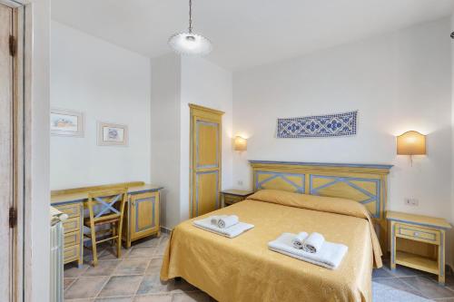 a bedroom with a bed with two towels on it at Camera a Dorgali al B&B Sa Madalena in Dorgali