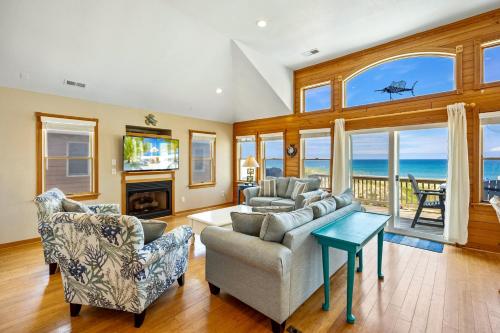 a living room with a view of the ocean at 7000 - Serenity Sands in Whalebone