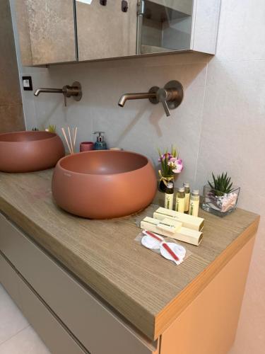 a bathroom with two sinks and towels on a counter at Virgin Mare in Giovinazzo