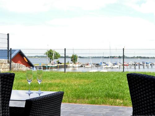 a table with two wine glasses sitting on top of it at Ferienhaushälfte "Ausblick" in Sundhagen-Niederhof