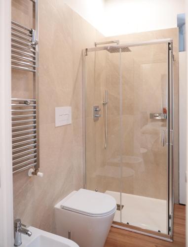 a bathroom with a shower and a toilet and a sink at Hortus slow room in Montesarchio