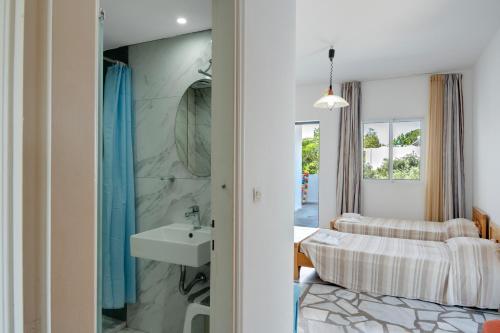 a bathroom with a sink and a mirror at Ilios and Irene 5 in Mastihari