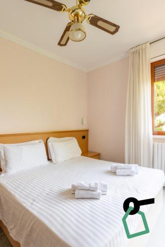 a bedroom with a bed with two towels on it at Hotiday Bordighera in Bordighera
