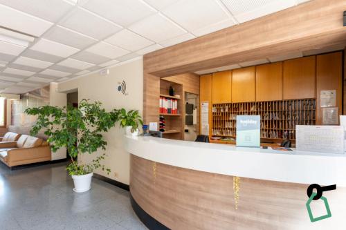 a lobby of a library with a reception counter at Hotiday Bordighera in Bordighera