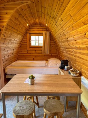 a room with a bed and a table in a cabin at UCamp Kemmelberg in Heuvelland