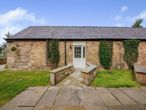 a brick house with a white door and ivy at Nightfold - Uk49890 in Preston