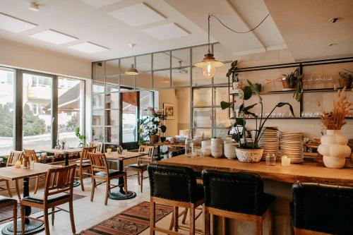 a restaurant with wooden tables and chairs and windows at Oslo Guldsmeden in Oslo