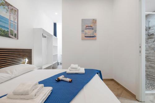 a bedroom with a bed with towels on it at Bikers Rooms in Sestu