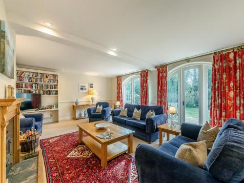 a living room with blue couches and a fireplace at Carriage House - Uk49288 in Preston