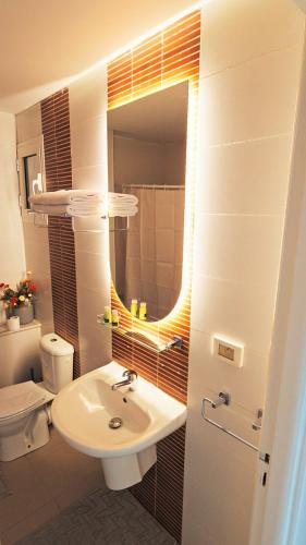a bathroom with a sink and a toilet and a mirror at Chez-moi in Sfax