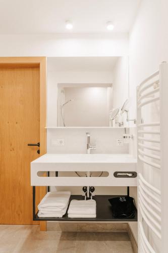 a white bathroom with a sink and a mirror at Frankenfelsberg in Oedrotte