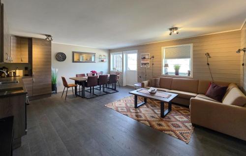 a living room with a couch and a table at Gorgeous Apartment In Drangedal in Drangedal