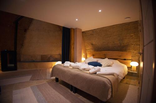 a bedroom with a bed with towels on it at L'Escapade in Baugé