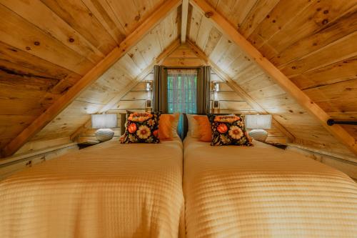 two beds in the attic of a log cabin at Peaceful Luxury in the Smokey Mountains w Hot Tub and Pet Friendly Cabin B in Elizabethton