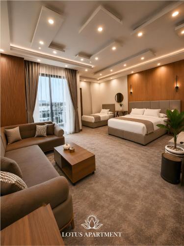 a hotel room with two beds and a couch at Lotus Two Hotel l New Cairo in Cairo