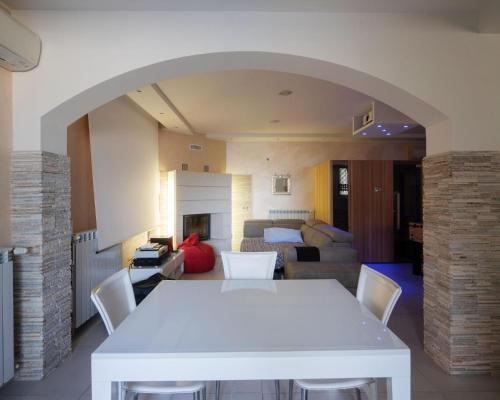 a living room with a white table and a couch at Villa Ennio in Ciampino
