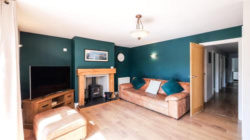 a living room with a couch and a television at Firsbrook House - Wark Northumberland in Wark