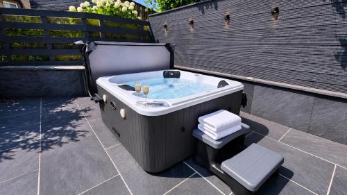 a hot tub sitting on top of a patio at Firsbrook House - Wark Northumberland in Wark