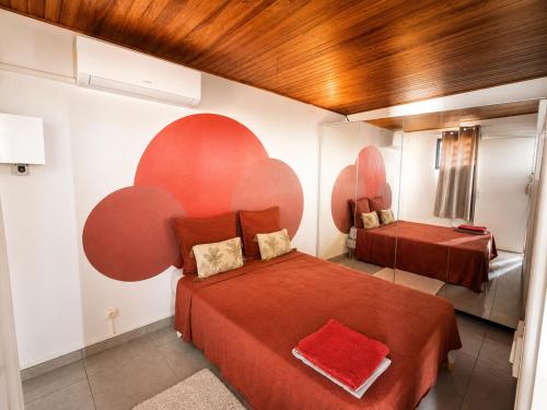 a bedroom with two beds with red sheets at URBAN LOFT- Espace détente in Fort-de-France