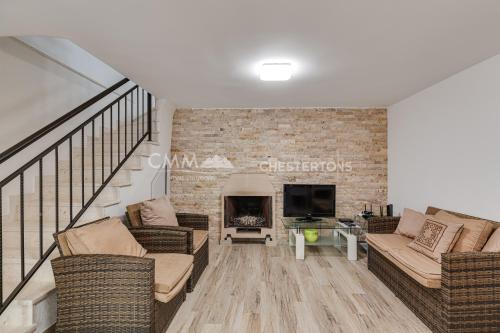 a living room with two couches and a fireplace at Villa Masha in Rijeka Reževići