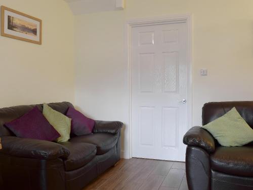 a living room with a couch and two chairs at 18 Elm Court in Keswick
