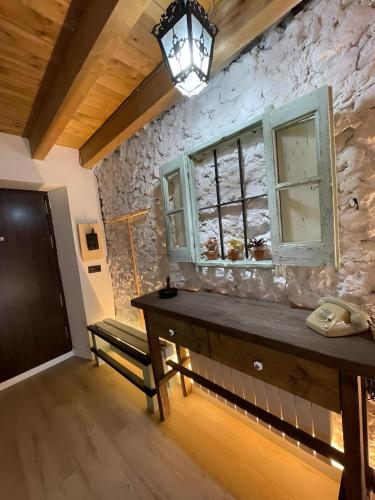 a room with a wooden table and a window at Verde & Mar in Castro-Urdiales