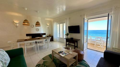 a living room with a view of the ocean at Beira Mar - Private Pool - 7 Guests - Albufeira in Albufeira