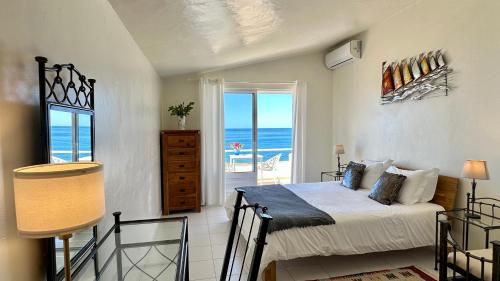 a bedroom with a bed and a view of the ocean at Beira Mar - Private Pool - 7 Guests - Albufeira in Albufeira