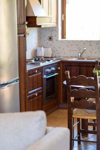 a kitchen with wooden cabinets and a stove top oven at Kahlua Bay Apartments in Hersonissos