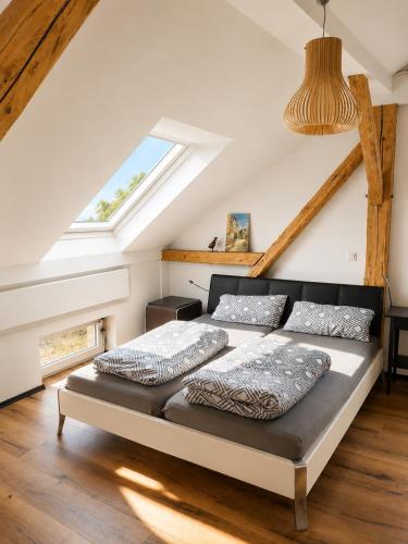 a bedroom with two beds in a attic at Bad Aibling City Apartment - Pano in Bad Aibling