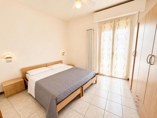 a bedroom with a bed and a large window at De Amicis Sea Home in Gabicce Mare