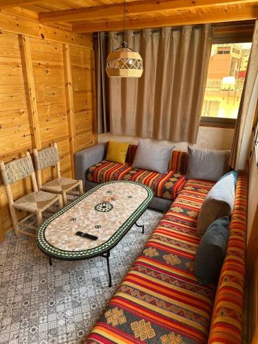 a living room with a couch and a table at Blue Drift in Imsouane