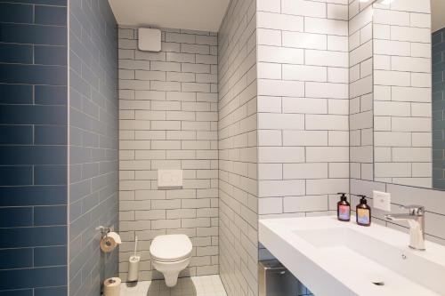 a bathroom with a white toilet and a sink at Geneva Youth Hostel in Geneva