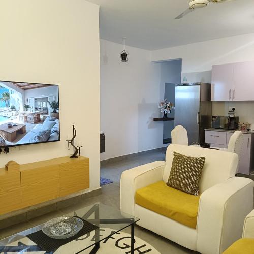 a living room with a couch and a tv at Zurilyn Crib in Malindi