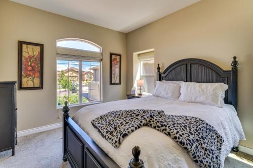 a bedroom with a leopard print bed with a window at Home w/ Golf Course, Mountain Views & EV Charging! in Peyton