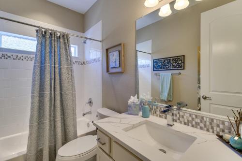 a bathroom with a sink and a toilet and a mirror at Home w/ Golf Course, Mountain Views & EV Charging! in Peyton
