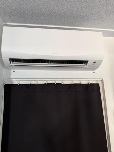 a ceiling mounted air conditioner above a window at Loviisan Helmi 102 in Loviisa