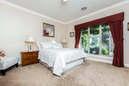 a bedroom with a large bed and a window at La Bella Vita in Batesford